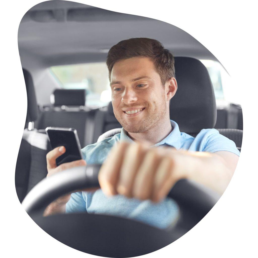 A rideshare driver holding a phone.